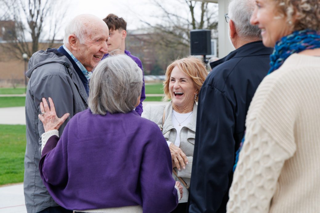 Group smiling talking to Stan