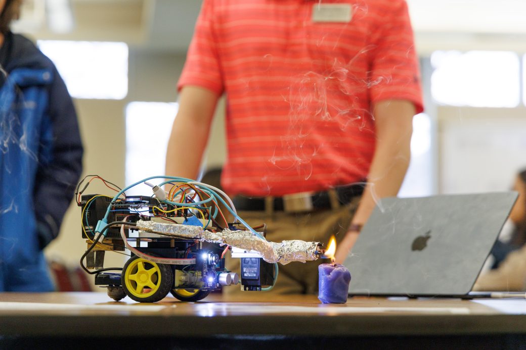Student robot lighting candle