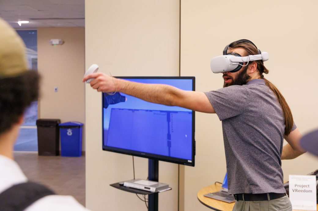 Student showing how to use VR