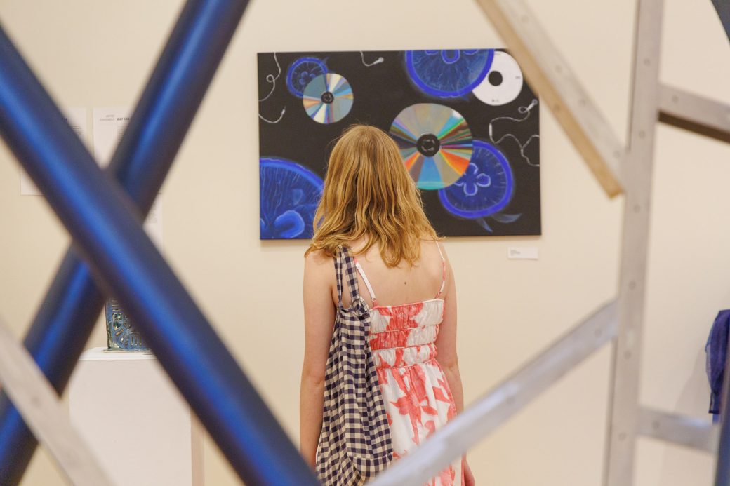 Student faces artwork away from camera