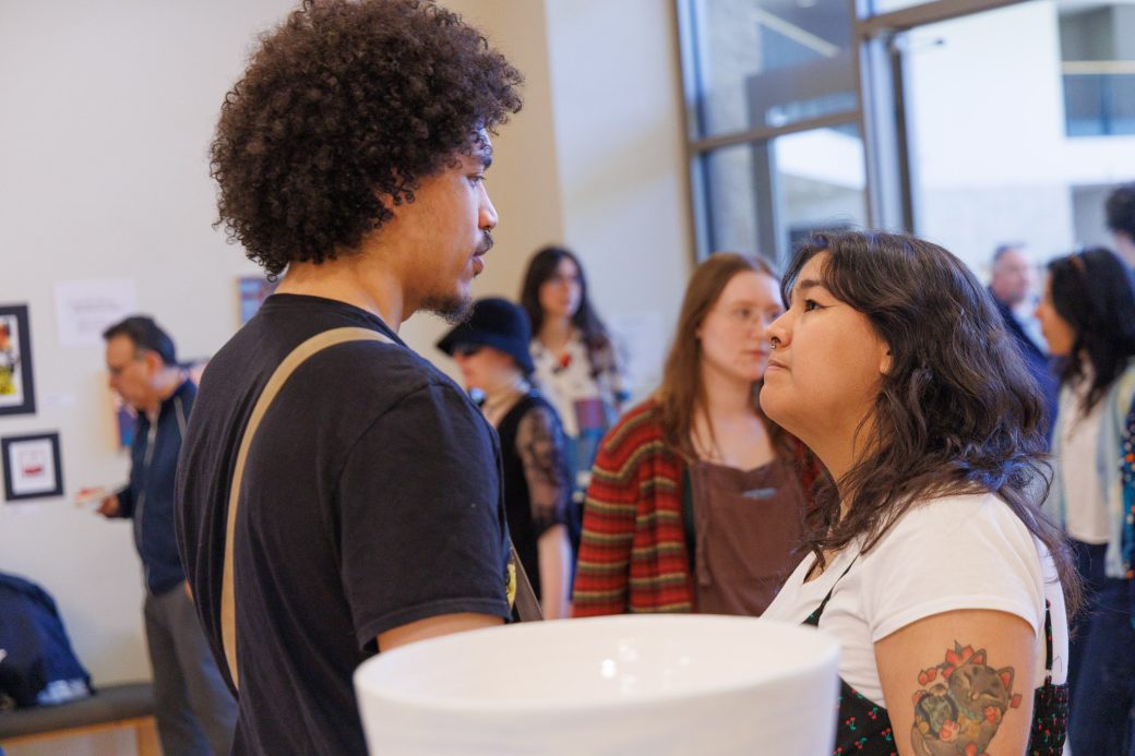 Students chat about artwork in gallery