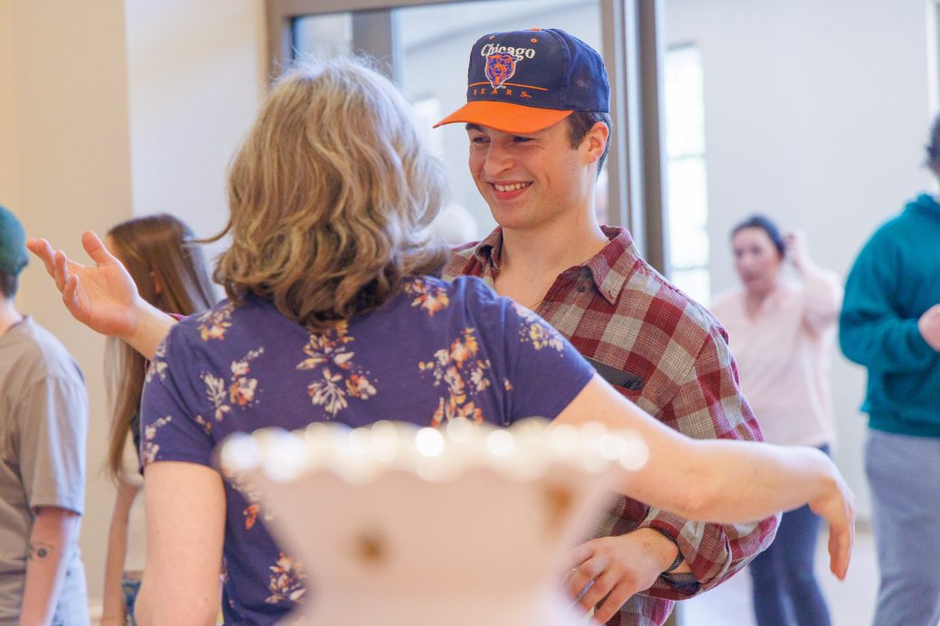 Student and faculty member hugging in greeting