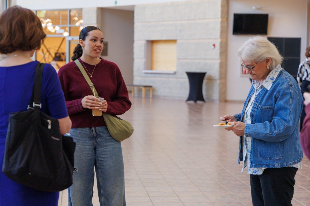 Student and staff talking in a group