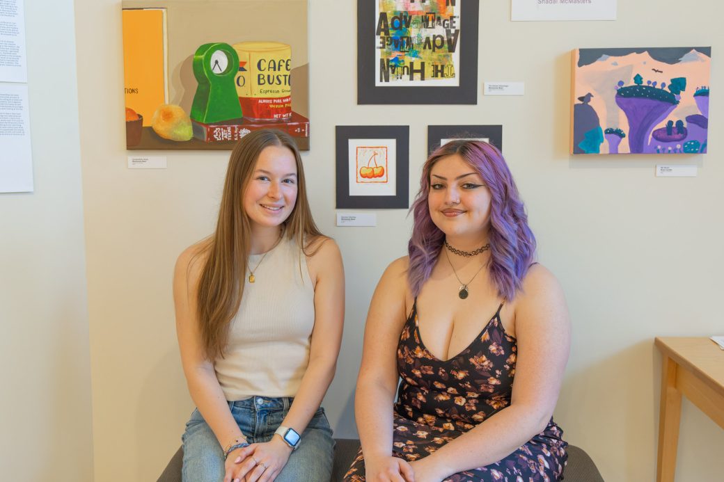 Two students seated smiling