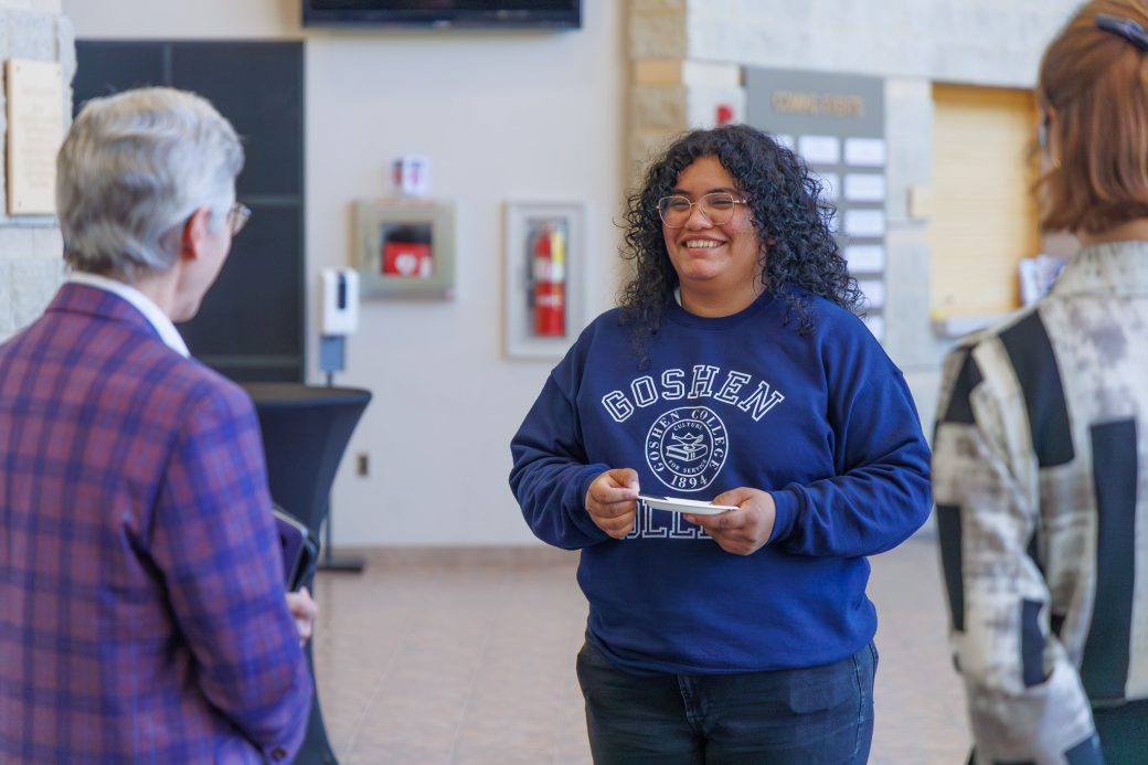 Student smiling in conversation