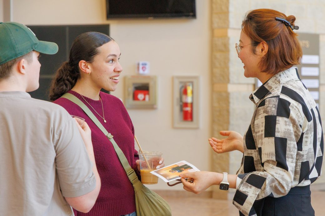 Faculty and student conversing