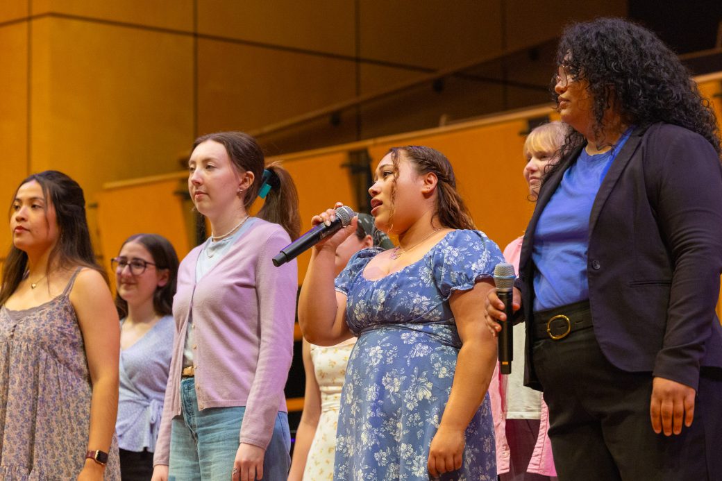 Students sing in a circle during baccalaureate