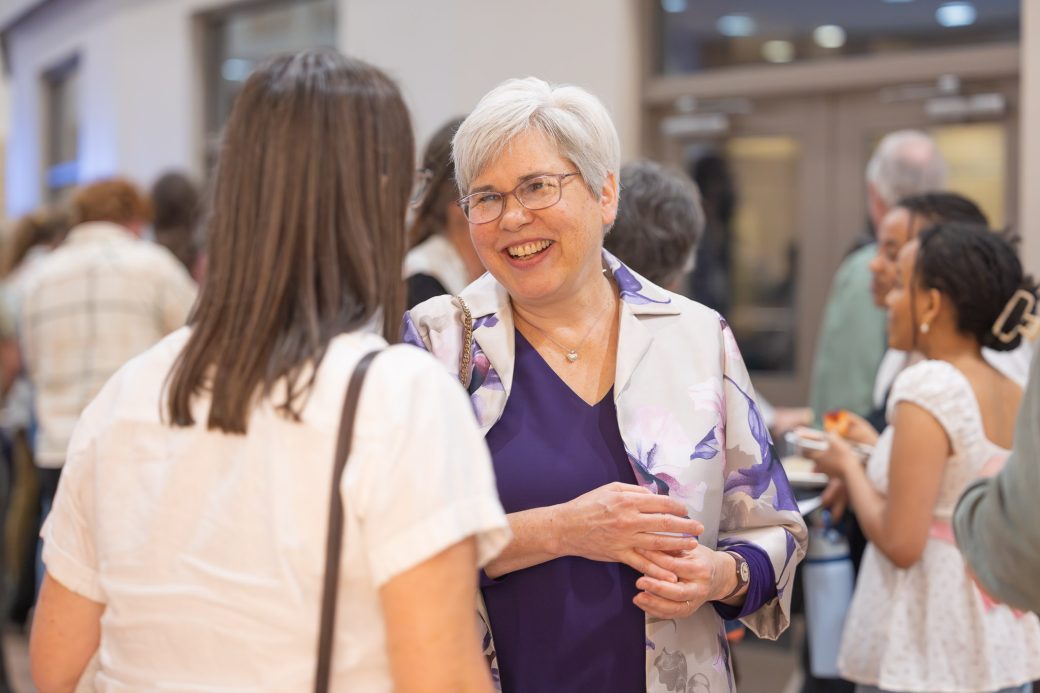 President Rebecca Stoltzfus talks to faculty and staff during reception