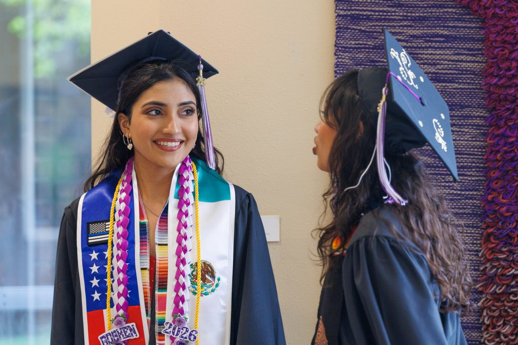 Two female graduate students talking