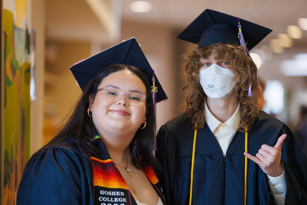 Male and female graduates smiling for a photo