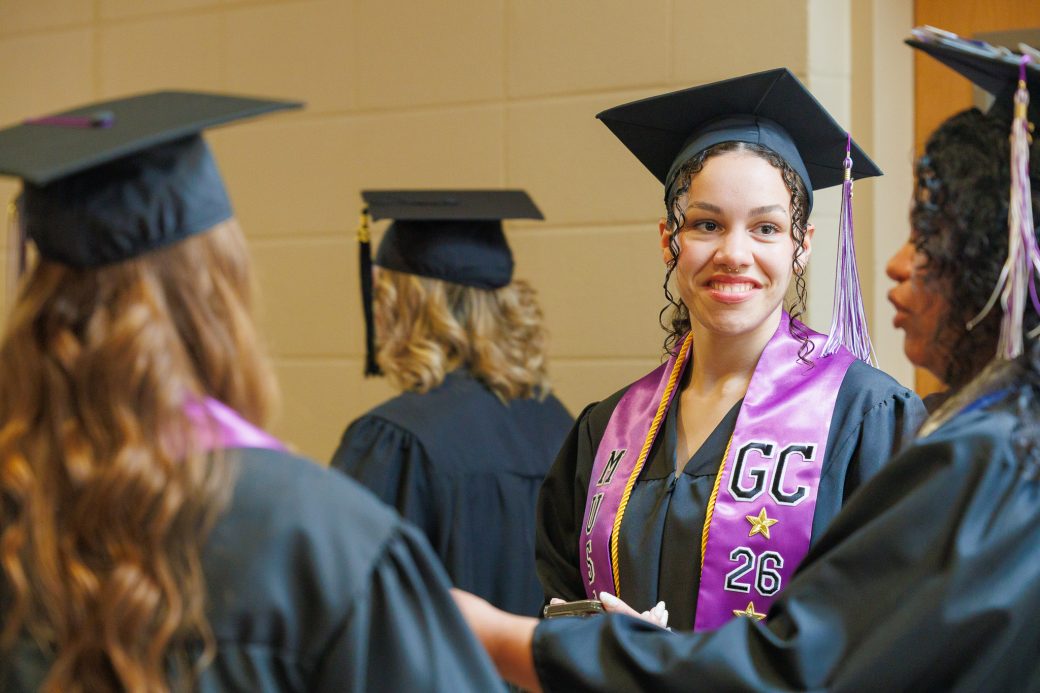 Smiling female graduate with colorful GC stole