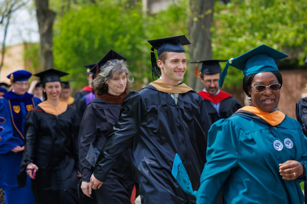 Justin DeWeese walking in graduation procession