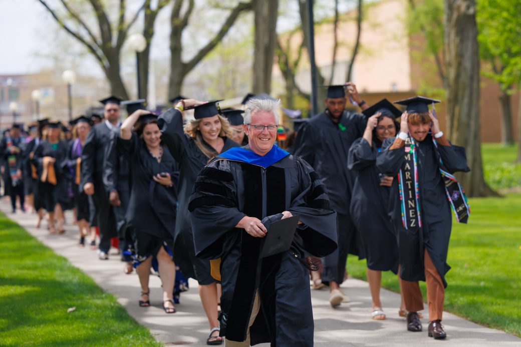College graduates proceeding to the Roman Gingerich Recreation-Fitness Center