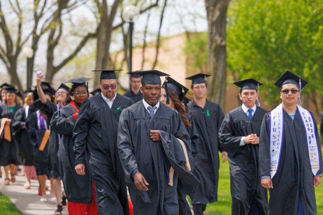 Serious male graduate walking in processional
