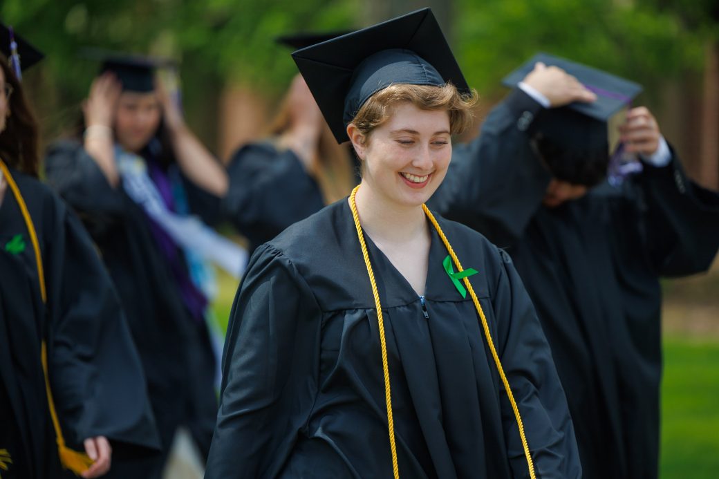 Kate Bodiker walking in graduation processional smiling