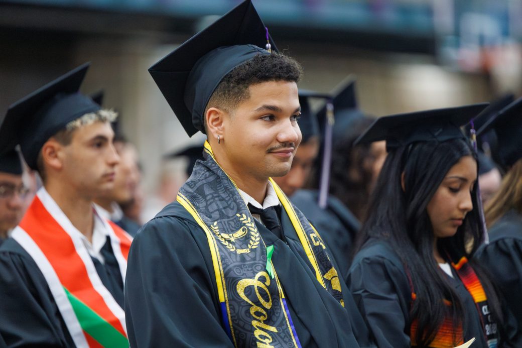 Close view of graduate sitting in graduate area during ceremony