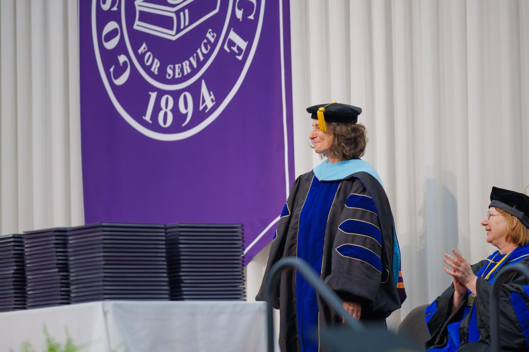 Kathy Meyer Reimer standing up in recognition of retirement