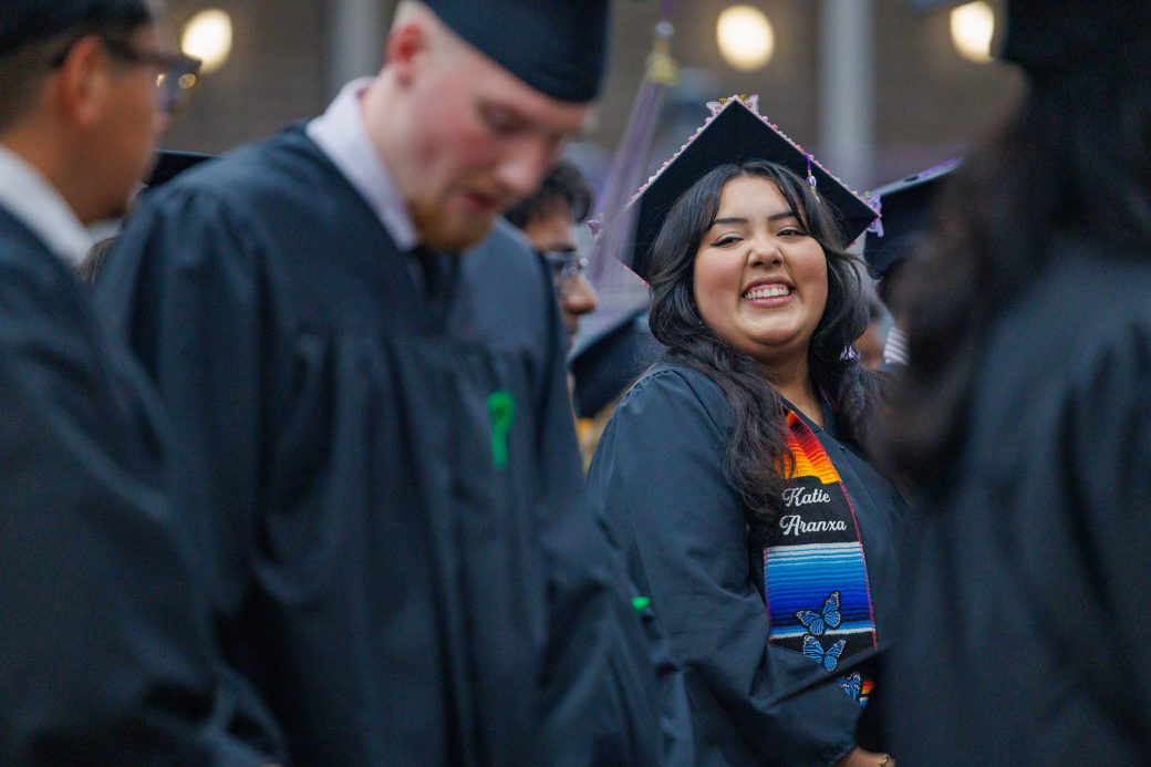 Smiling graduate about to get her diploma