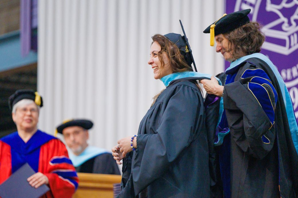 Female graduate smiling with sash placed