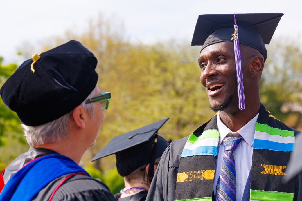 Graduate speaking with faculty member