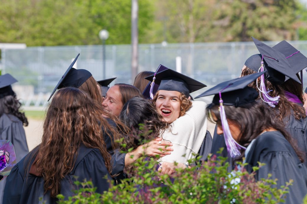 Graduates hugging other graduates