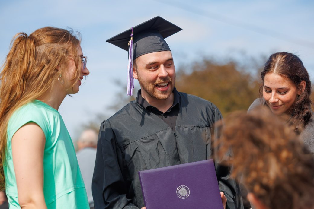 Graduate outside with diploma
