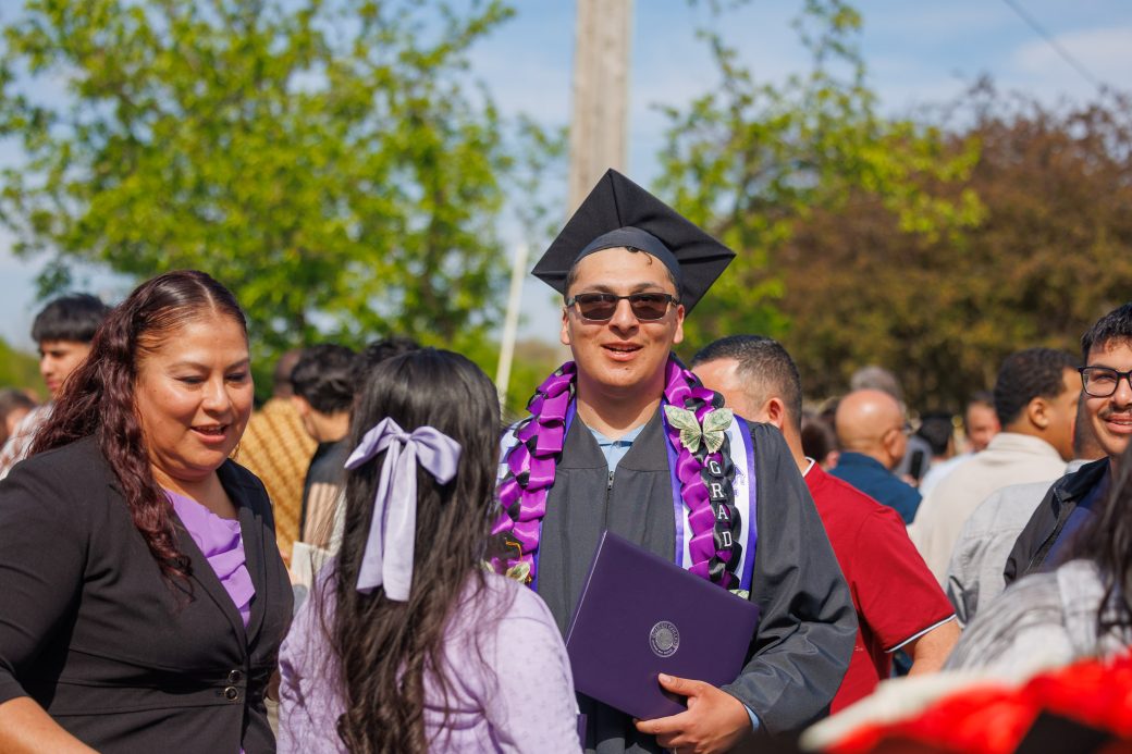 graduate with sunglasses outside