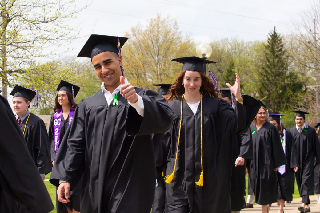 Male graduate student giving thumbs up