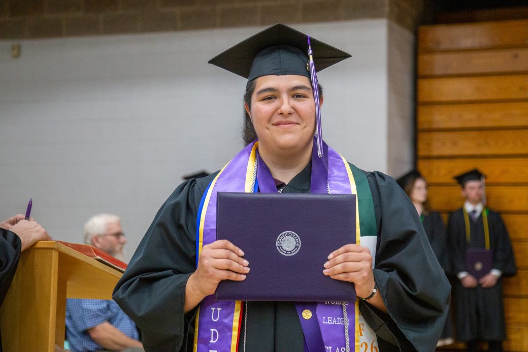 T holding diploma they just received