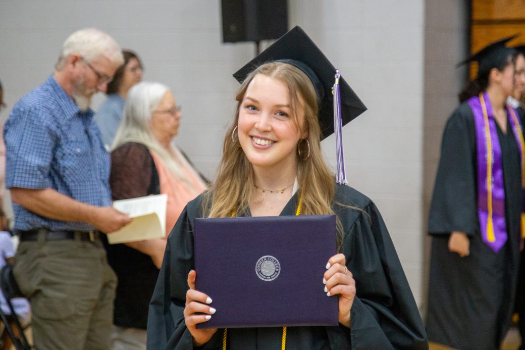 Graduate holding diploma and celebrating milestone moment