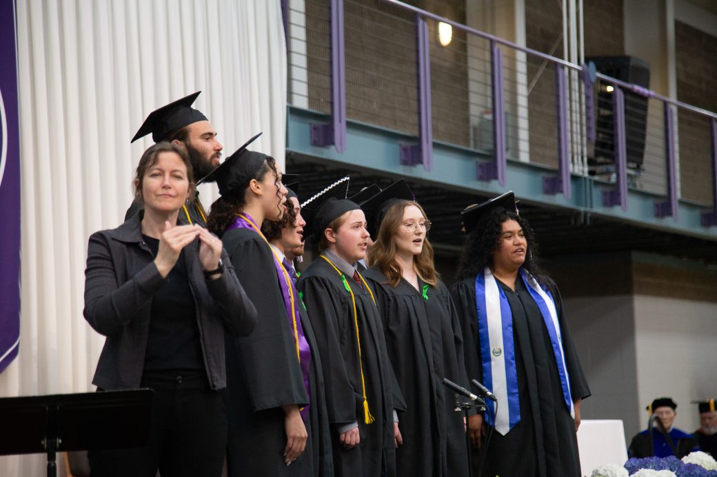 Graduates singing as part of benediction at ceremony conclusion
