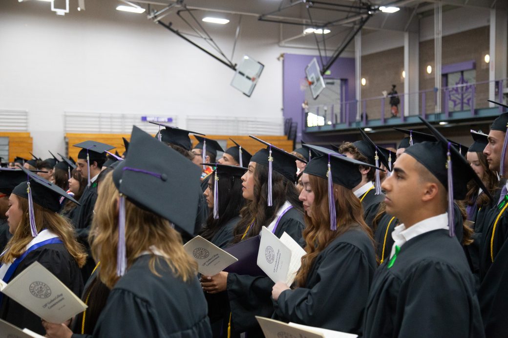 Graduates singing together during closing benediction ceremony