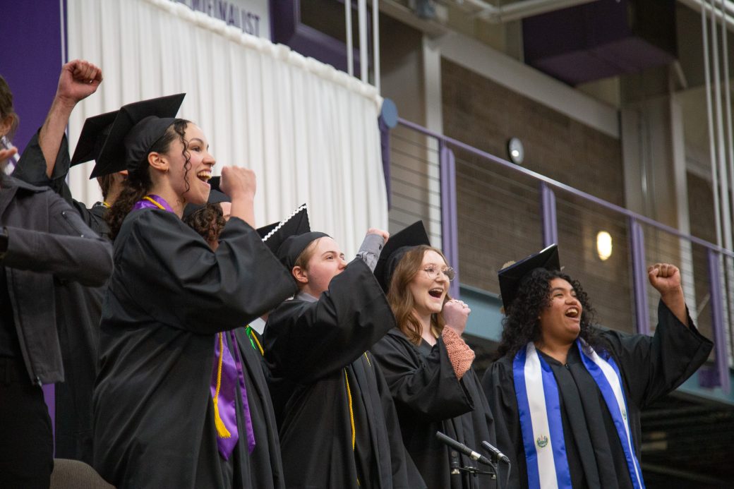 Group of students singing in harmony during commencement benediction