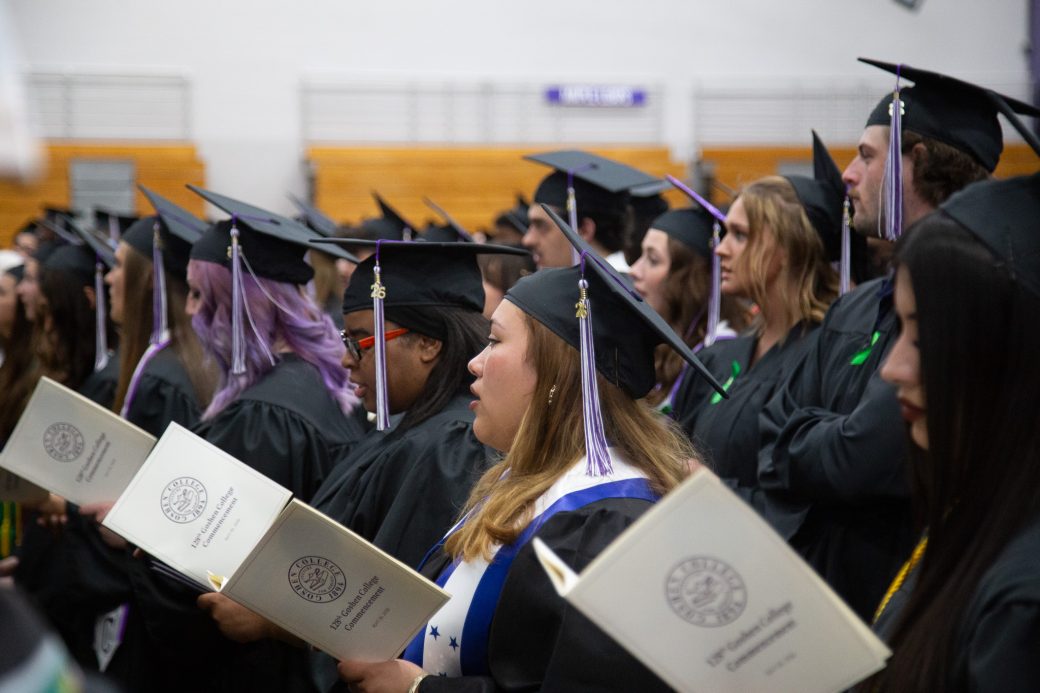 Group of students performing song during commencement benediction