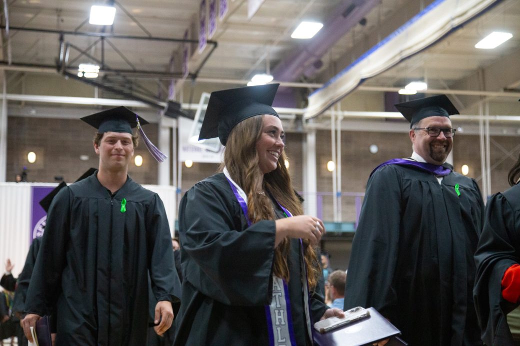 Students exiting commencement together after ceremony concludes