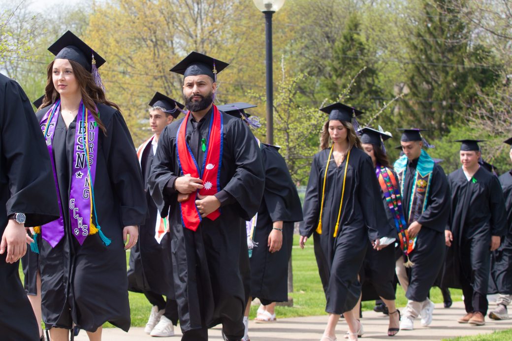 Male graduate walking in processional to graduate