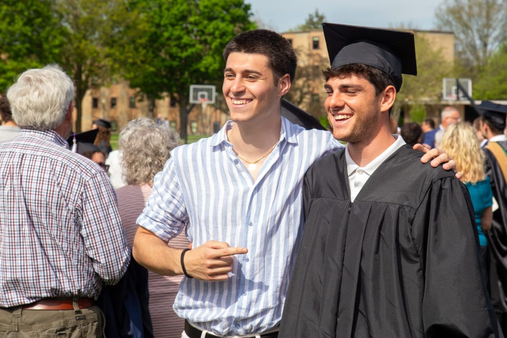 Graduate celebrating milestone with family and friends on campus