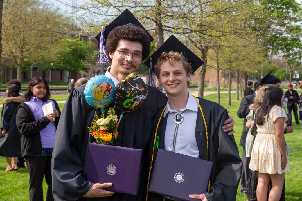 Two graduates posing together