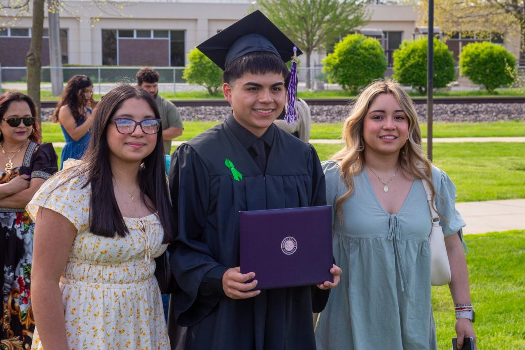 Graduate posed with friends after ceremony