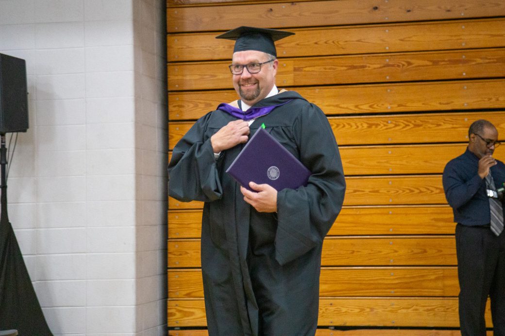 Marshall King holding his diploma