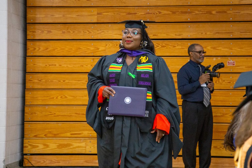 Graduate holding diploma after walking the stage