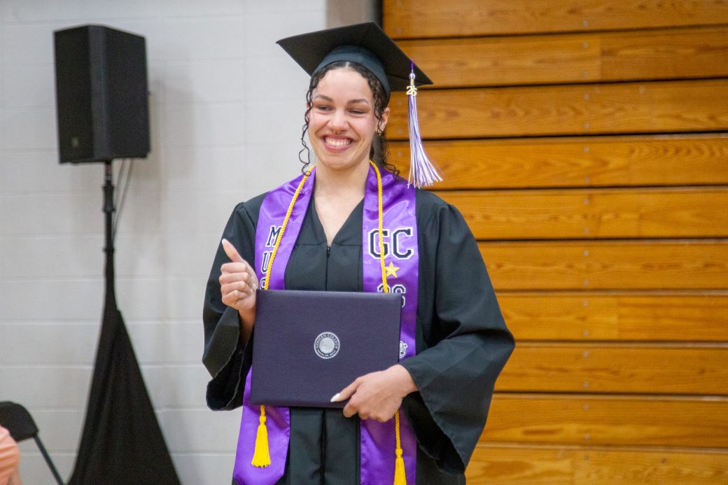 Asia smiling after receiving diploma