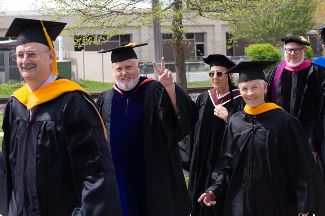 Goshen College professor giving peace sign