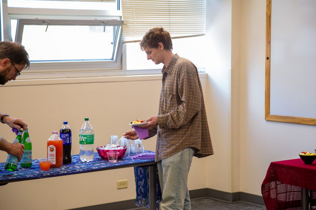 Student grabbing food at snack table