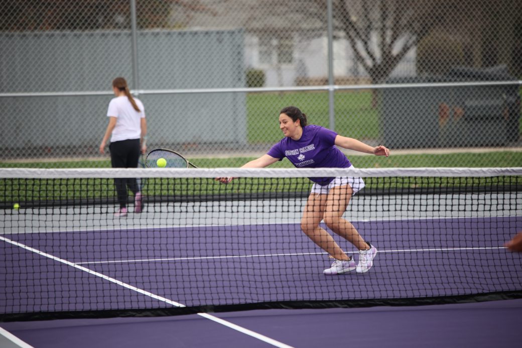 Tennis player hitting ball