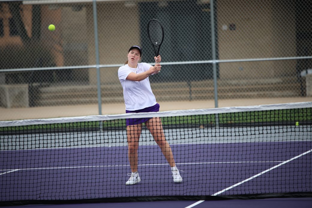 Tennis player hitting ball
