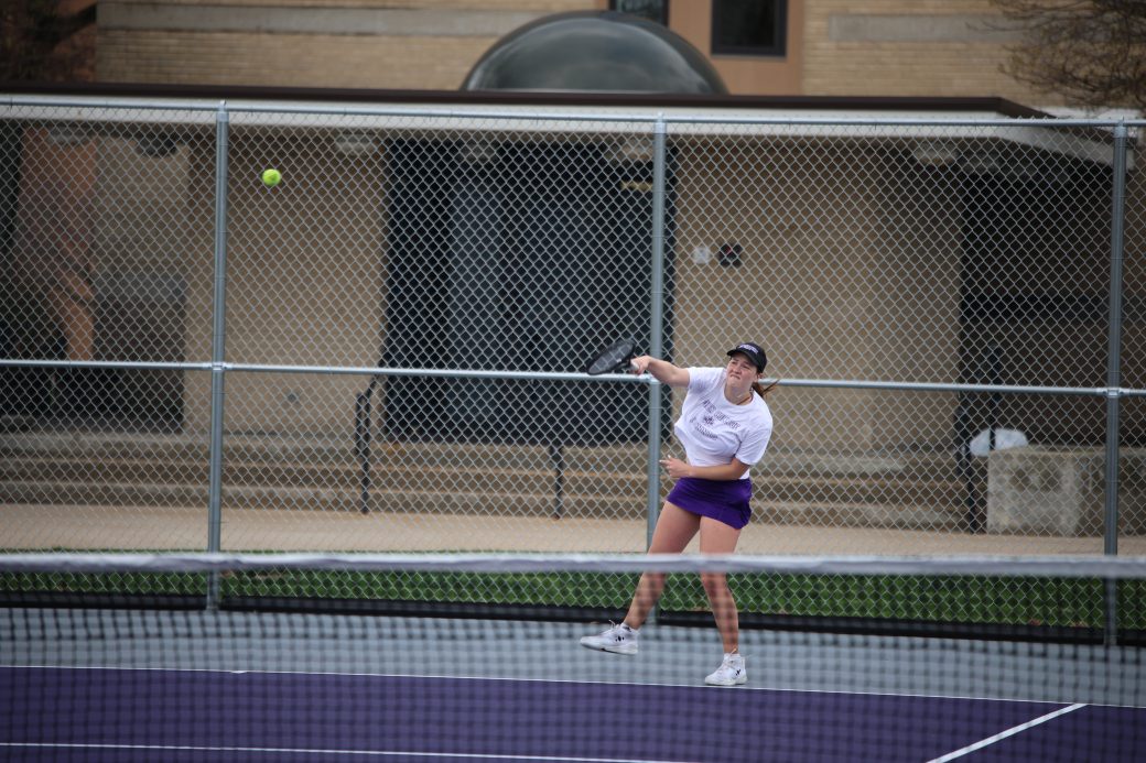 Tennis player hitting ball