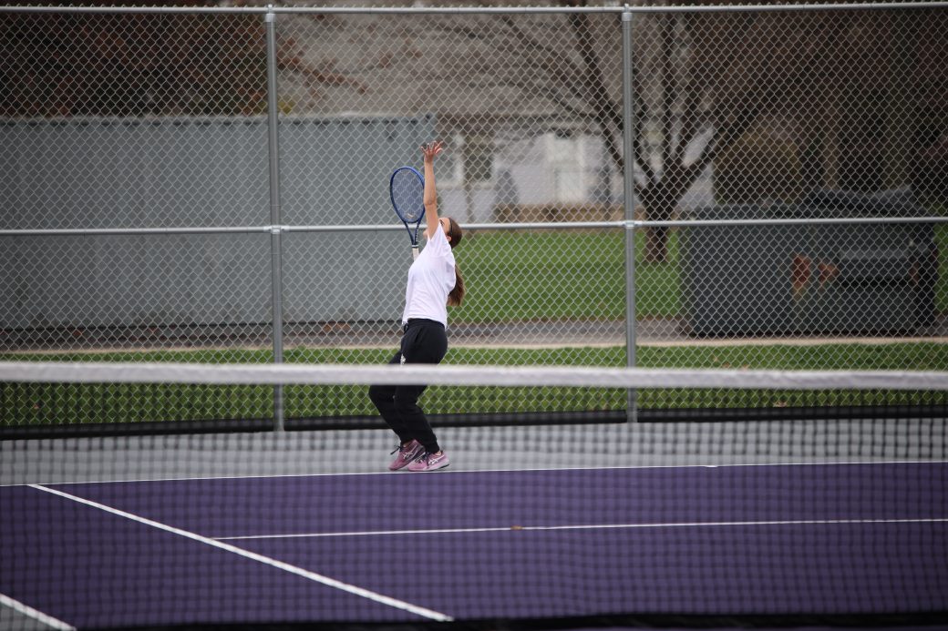 Tennis player hitting ball