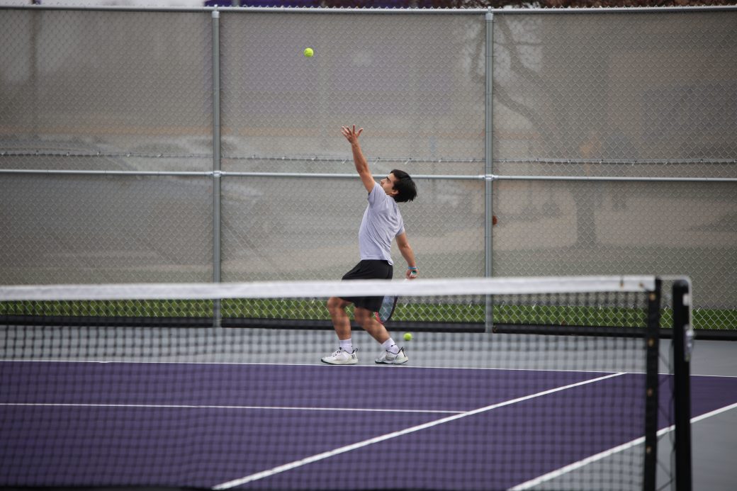 Tennis player hitting ball