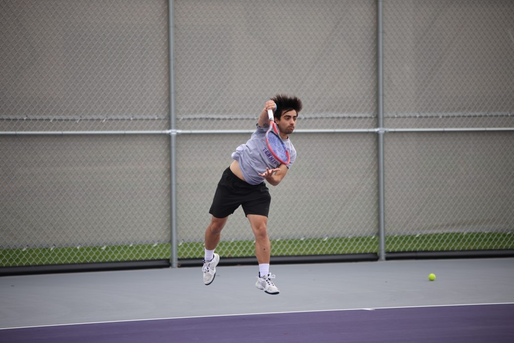 Tennis player hitting ball